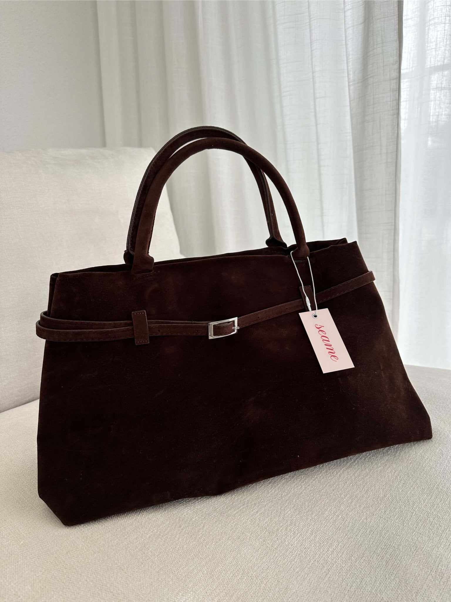 Women’s satchel bag in suede-look material with strap closure and short handle