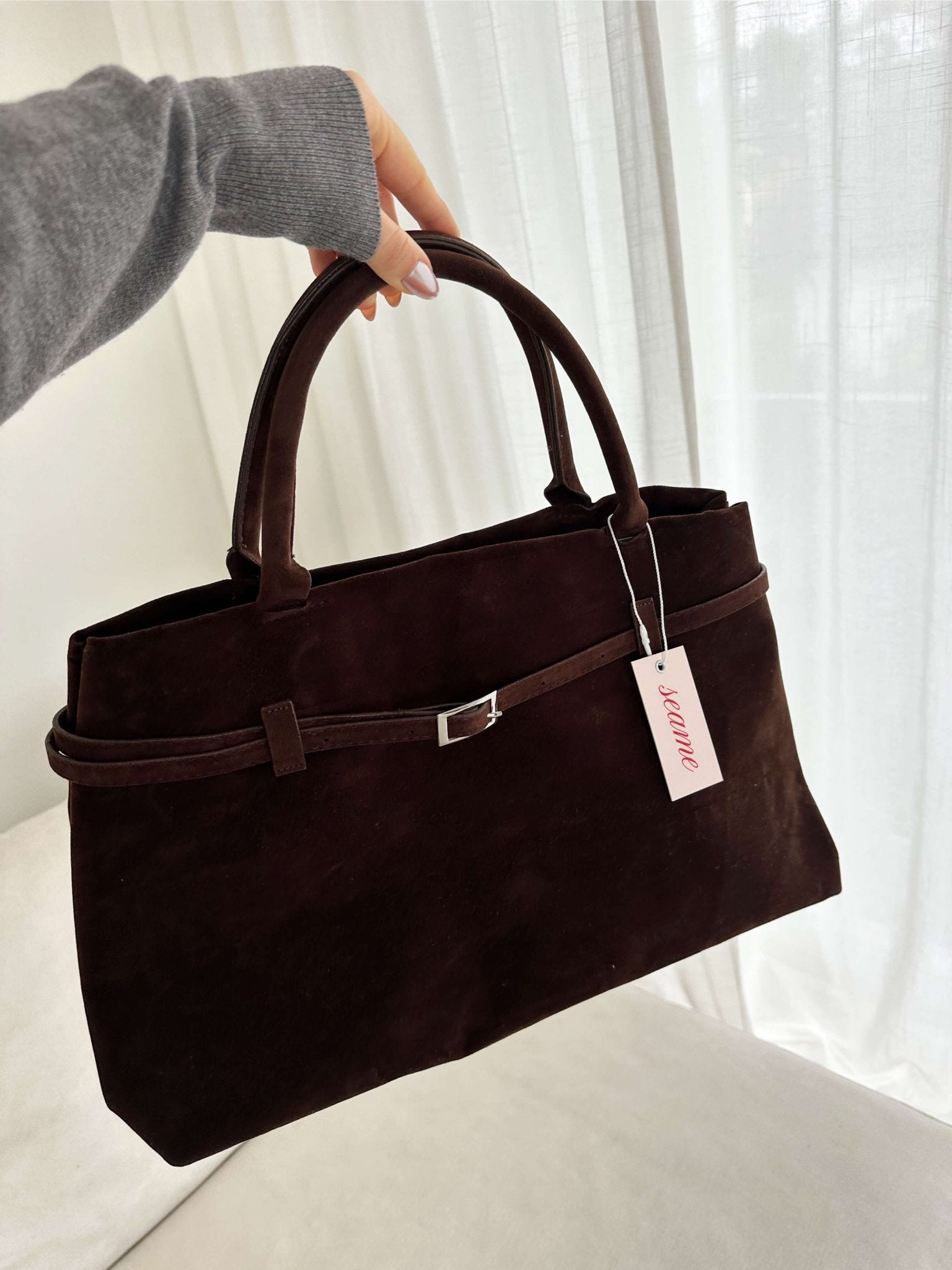 Women’s satchel bag in suede-look material with strap closure and short handle