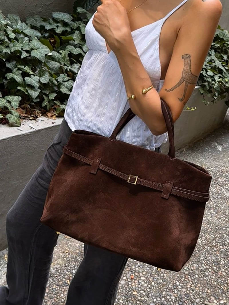Women’s satchel bag in suede-look material with strap closure and short handle