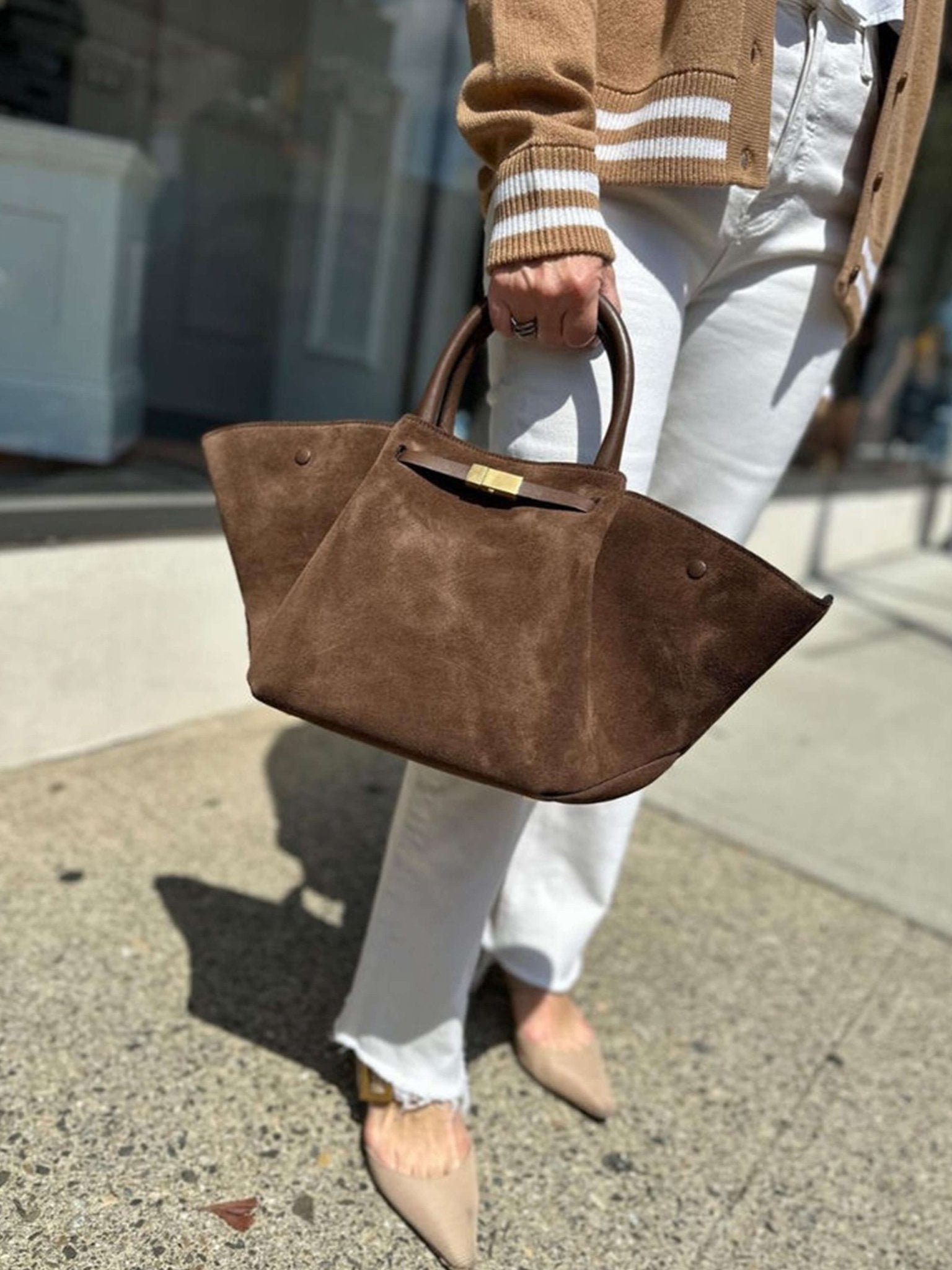 Women’s trapeze-shaped handbag in suede-look material with handles, strap closure, and shoulder strap